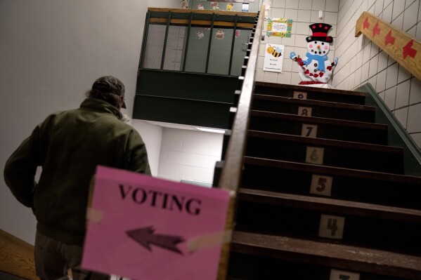 An image of a snowman greets voters entering a polling site to cast their ballots in the New Hampshire presidential primary in Manchester, N.H., Tuesday, Jan. 23, 2024. (AP Photo/David Goldman)